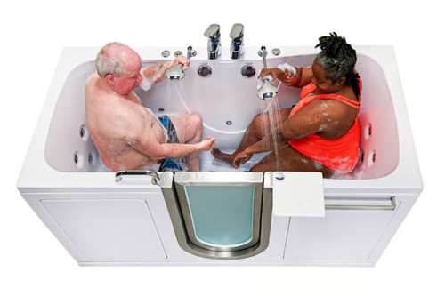 Elderly couple enjoying a comfortable soak together in a two-seat walk-in tub with dual shower wands